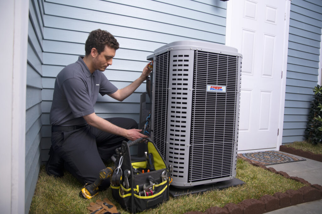 HVAC technician installing new air conditioner unit for replacement and upgrade.
